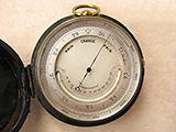 19th century pocket barometer with curved thermometer in case.
